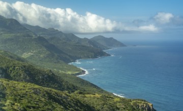 Sardinia, Mountainous coastal landscape by the sea, blue sky with clouds, Villanova Monteleone,