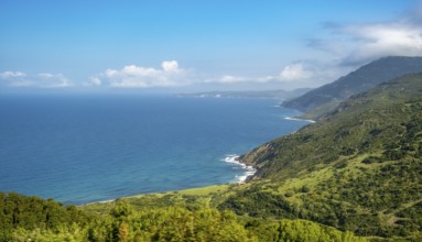 Sardinia, mountainous coastal landscape by the sea, blue sky with clouds, Bosa, Europe, Province of
