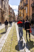 Sardinia, tourists in a pedestrian zone, artistic balconies and flower arrangements, Bosa, Europe,