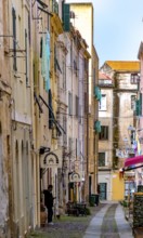 Sardinia, alley in the old town, fabric panels on the balconies and lamps, Alghero, Europe,