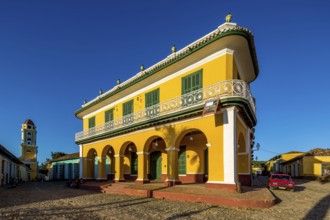 Centre of Trinidad Palacio Brunet, yellow palace with blue sky and the church Convento de San