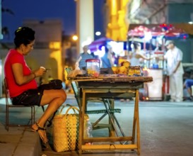 Private shop, street stall, trader counting money, streetlife in the city centre of Santa Clara at