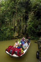 Exit of the cave system, tourists in an electric boat with life jackets, caves of the Indios, Cueva