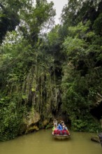 Exit of the cave system, tourists in an electric boat with life jackets, caves of the Indios, Cueva