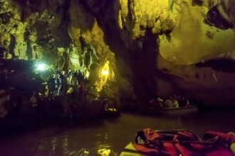 Tourists in a boat on the underground rivers in the caves of the Indios, Cueva del Indio,