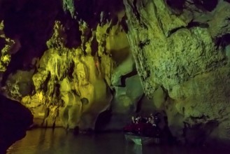 Tourists in a boat on the underground rivers in the caves of the Indios, Cueva del Indio,
