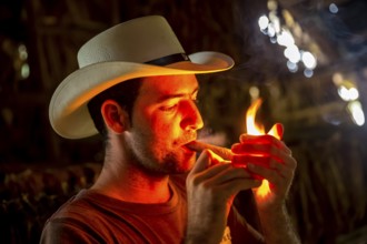 Tobacco farmer, tobacco farmer Luis Manne Alvares Rodrigues lights a Havana cigar, tobacco farm in