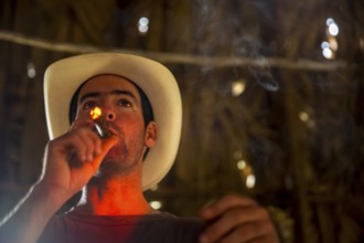 Tobacco farmer, tobacco farmer Luis Manne Alvares Rodrigues lights a Havana cigar, tobacco farm in