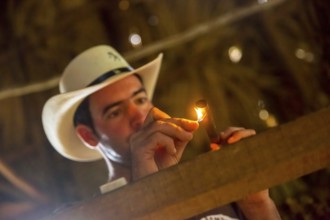 Tobacco farmer, tobacco farmer Luis Manne Alvares Rodrigues lights a Havana cigar, tobacco farm in