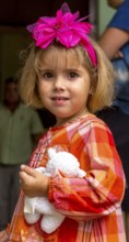 Little Cuban girl with white teddy bear and pink bow in her hair, Pink bow, Viñales, Cuba, Pinar