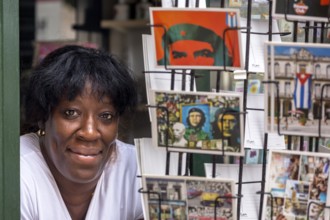 Kiosk saleswoman, Cuban, postcard stand with postcards of Ernesto Che Guevara, La Habana, Cuba,
