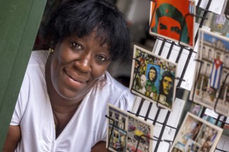 Kiosk saleswoman, Cuban, postcard stand with postcards of Ernesto Che Guevara, La Habana, Cuba,
