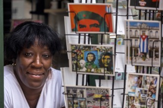Kiosk saleswoman, Cuban, postcard stand with postcards of Ernesto Che Guevara, La Habana, Cuba,