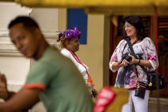 Old Cuban woman with cigar addresses tourists, La Habana, Havana, Cuba, Cuba, Europe, aerial view,