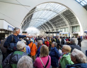 Tourists at Bergen railway station, tour guide, glass dome roof, train, Bergen, Hordaland, Norway,