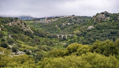 Sardinia, rugged granite mountains of Gallura, quarries and viaduct in hilly landscape, Olbia,
