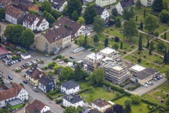Aerial view, construction site with new building on the main road at the cemetery, left Städt. Kita