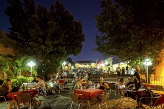 Restaurant and pub in the old town of Trinidad with visitors at the blue hour, tourists at tables,
