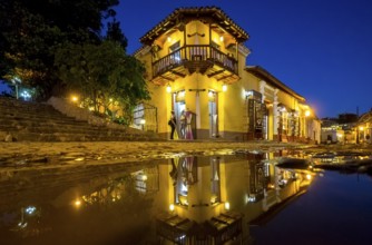 Restaurant and pub in the old town of Trinidad with visitors at the blue hour, Trinidad, Cuba,