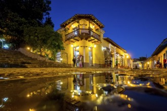 Restaurant and pub in the old town of Trinidad with visitors during the blue hour, Trinidad, Cuba,