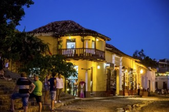 Restaurant and pub in the old town of Trinidad with visitors during the blue hour, Trinidad, Cuba,