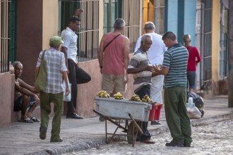 Banana vendor with his stall on the street, Street scene in the old town of Trinidad, Trinidad,