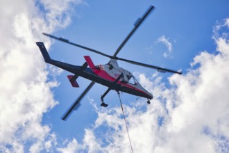 Helicopter flying high in the sky on a clear day, transport helicopter, timber transport, Saas
