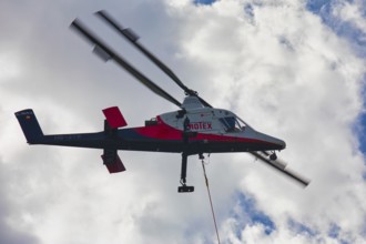 Aerial view of a helicopter with clouds in the background, transport helicopter, timber transport,