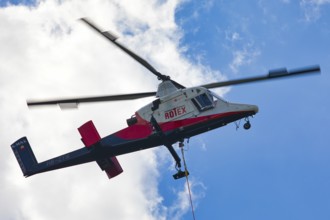 Detailed view of a helicopter with Rotex logo in the sky, transport helicopter, timber transport,