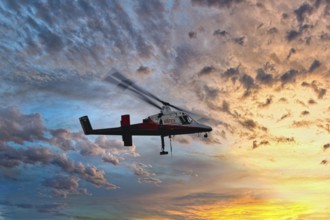 A helicopter flies in front of a colourful sunset with dramatic cloud formations, transport