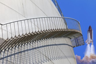 A rocket launches next to a large tank with a metal staircase in the foreground, elevated tank,