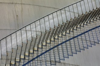 Close-up of a metal staircase with detailed shadows on the tank surface, elevated tank, chemical,