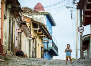Little boy with nappies standing on the street, street scene in the old town of Trinidad, Trinidad,