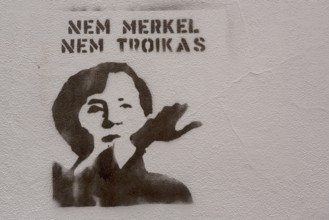Protest Gafitti against Merkel and Troika with raised arm and Hitler salute, Political protest in