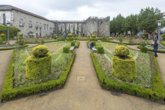 Jardim de Santa Barbara borders the crenellated facade of Antigo Paco Episcopal, former