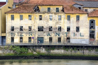 Old warehouse on the Douro, decay, labelling Mercantil, Oporto, Porto district, Portugal, Europe,