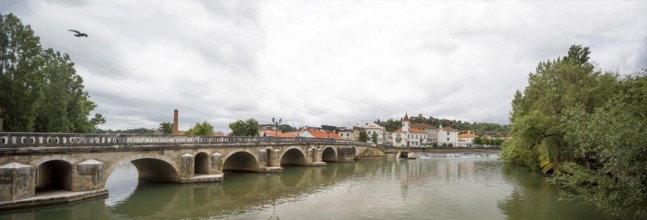 Renaissance bridge Ponte Velha over the Nabao near the old town of Tomar with the Convento de