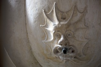 Devil's grimace on a fountain in the cloister, Monastery of Santa Maria da VitÃüria, UNESCO World