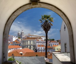 View over the red roofs and through an archway of Lisbon to the Cathedral SÃ©, Lisbon, Lisbon