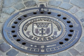 GdaÅsk, decorated manhole cover, city of Gdansk, Gdansk, Baltic Sea coast, Baltic Sea, pomorskie,
