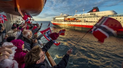 Tourists at the ship's railing, ship MS Finnmarken, Norwegian flags, Mehamn, Finnmark, Norway,