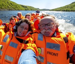 Selfie, tourists with life jackets, river trip with tourists on an excursion boat in a headwind,
