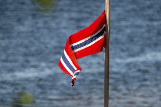 Norwegian flag on the river, Kirkenes, Finnmark, Norway, Scandinavia, Europe, adventure travel,