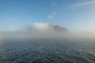Island in the fog, Kjøllefjord, Finnmark, Norway, Scandinavia, Europe, adventure travel, tourism,