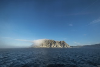 Island in the fog, Kjøllefjord, Finnmark, Norway, Scandinavia, Europe, adventure travel, tourism,