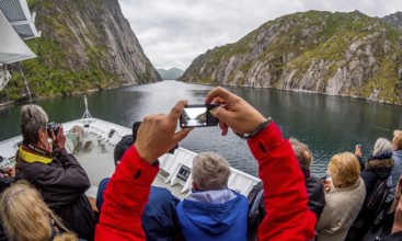 Cruise in a fjord, ship bow, photographing tourists, Digermulen, Nordland, Norway, Scandinavia,