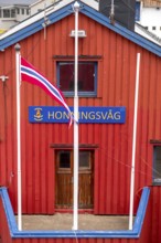 Red Norwegian house with town sign, Måsøy, Finnmark, Norway, Scandinavia, Europe, adventure trip,