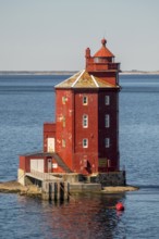 Kjeungskjær Fyr, red lighthouse, off the Norwegian coast on a small archipelago off Ã˜rland,