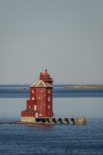 Kjeungskjær Fyr, red lighthouse, off the Norwegian coast on a small archipelago off Ã˜rland,