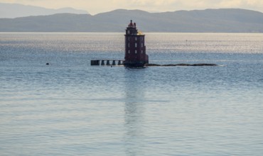 Kjeungskjær Fyr, red lighthouse, off the Norwegian coast on a small archipelago off Ã˜rland,